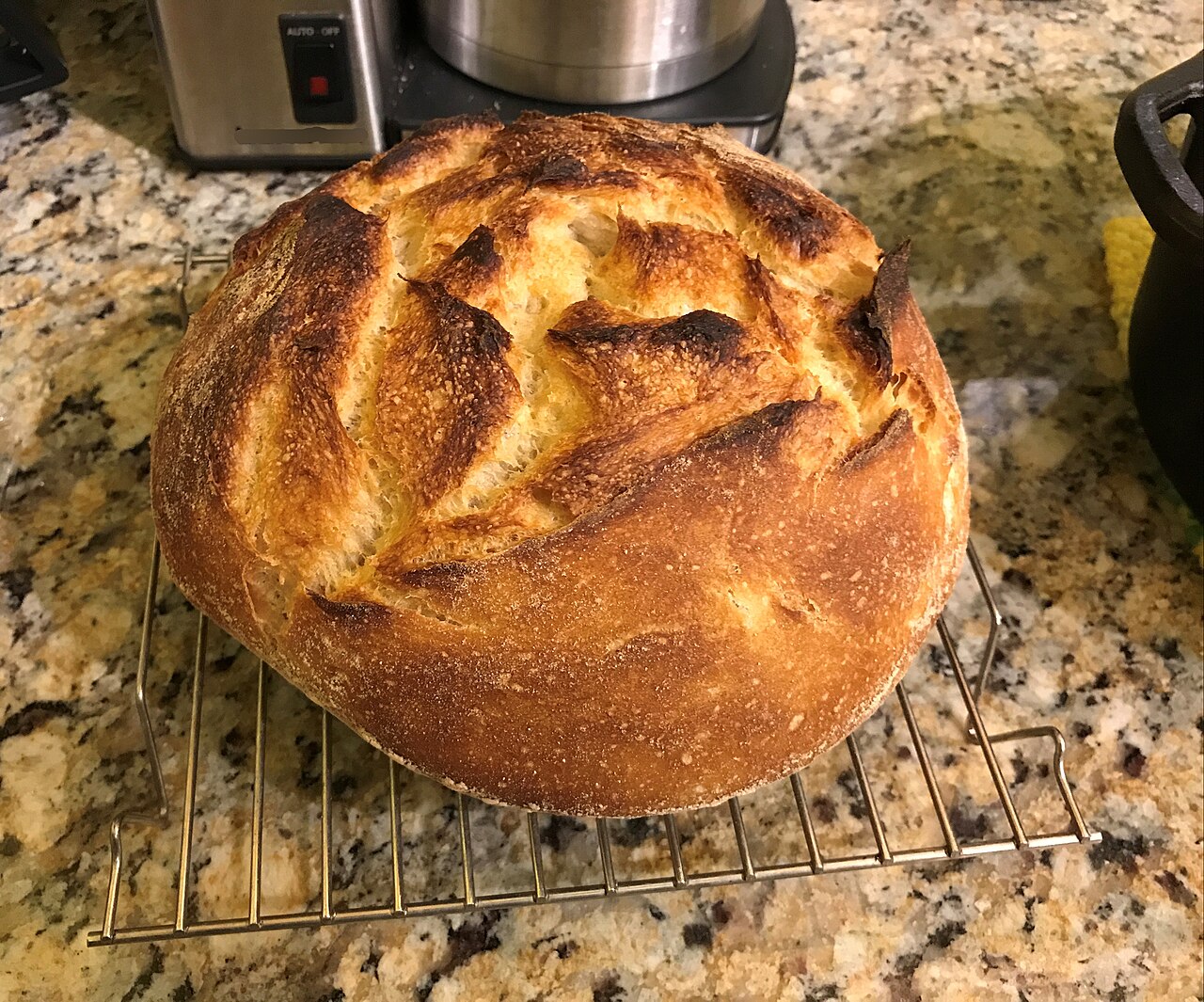 Sourdough loaf cooling on a wire rack
